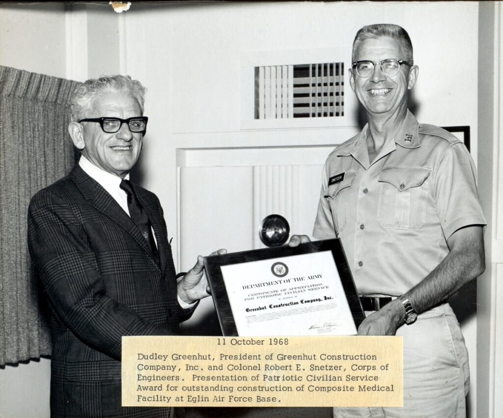 Dudley Greenhut, founder of Greenhut Construction Company, receiving a recognition award in Pensacola